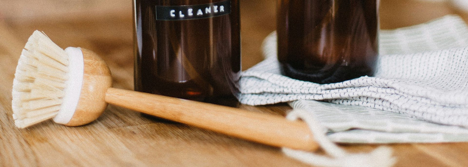 cleaning brush next to bottles