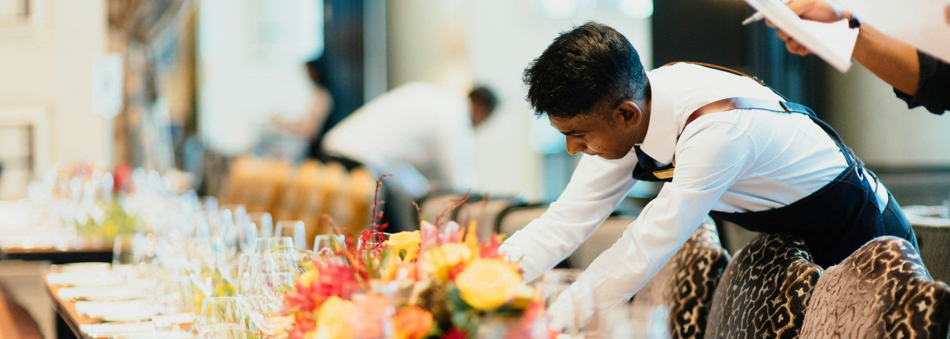 Hospitality worker laying a table