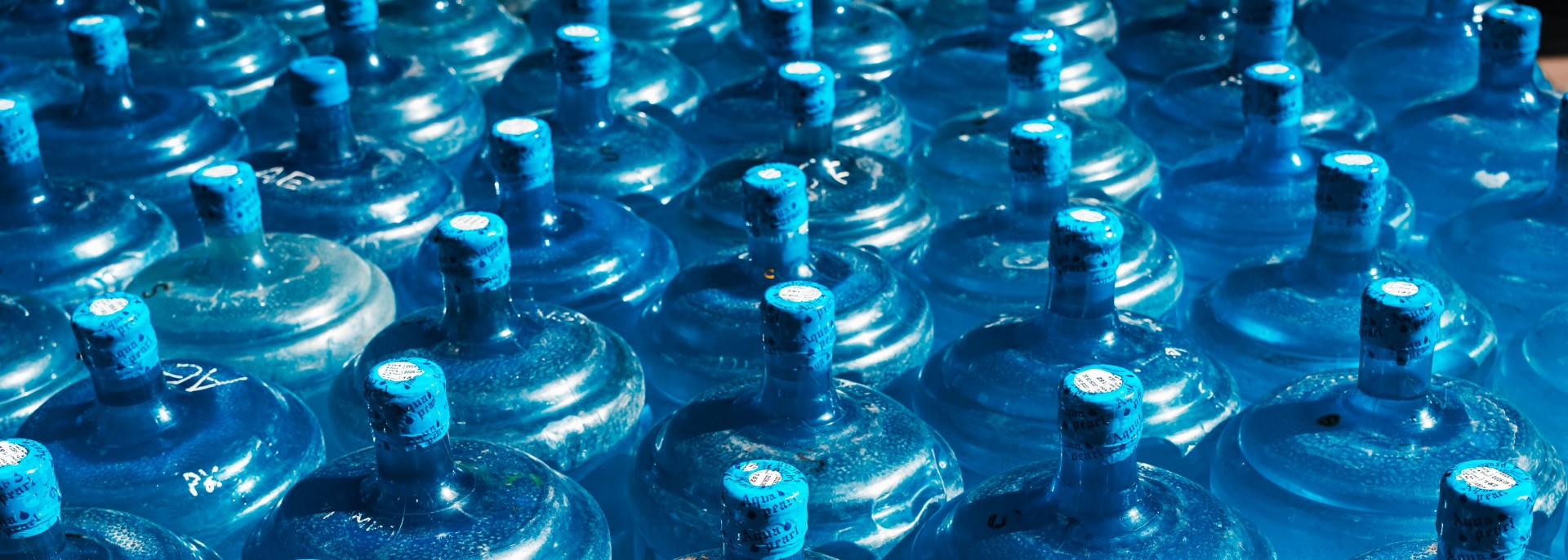 many plastic water bottles next to each other