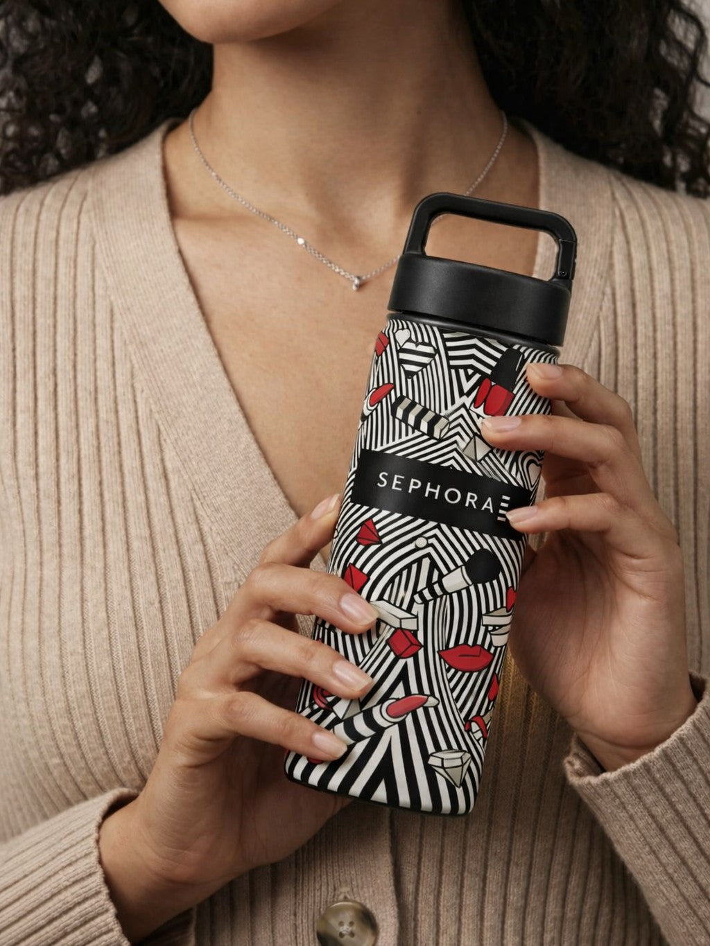 Person holding a custom branded Sephora water bottle