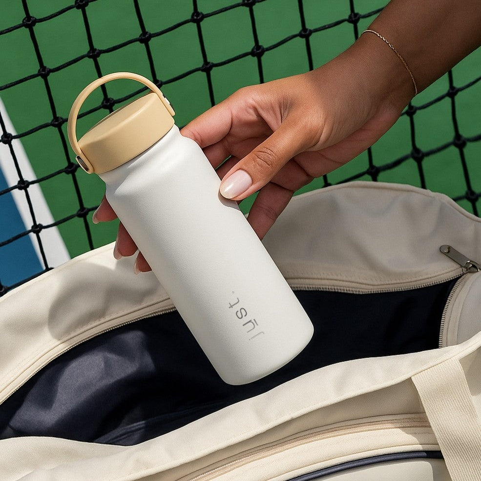 white reusable water bottle with beige lid
