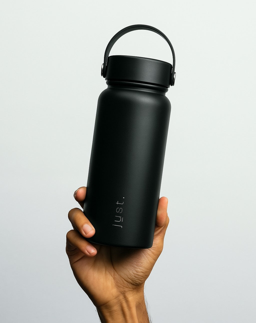 person holding a large black reusable water bottle