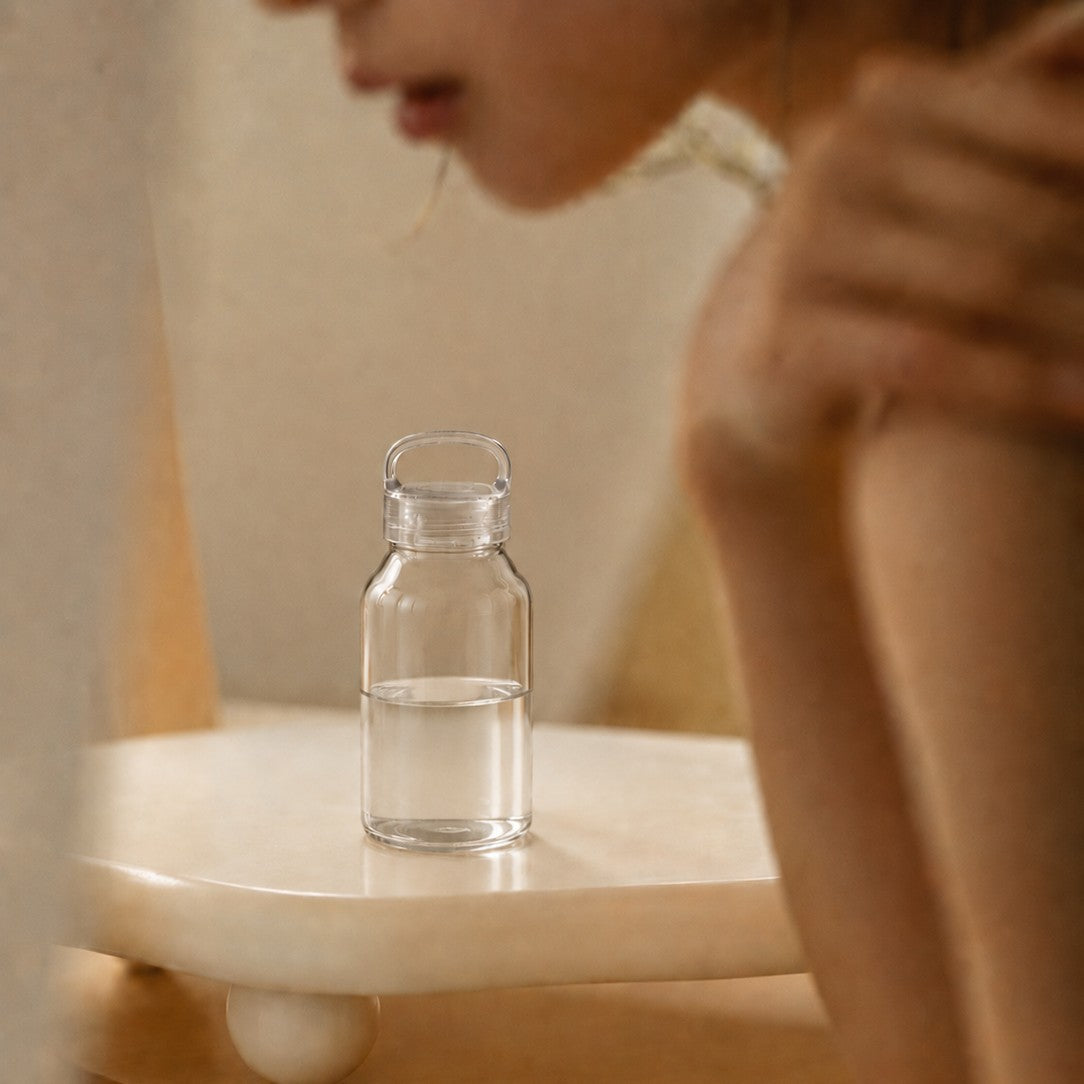 Small clear glass borosilicate water bottle on a table