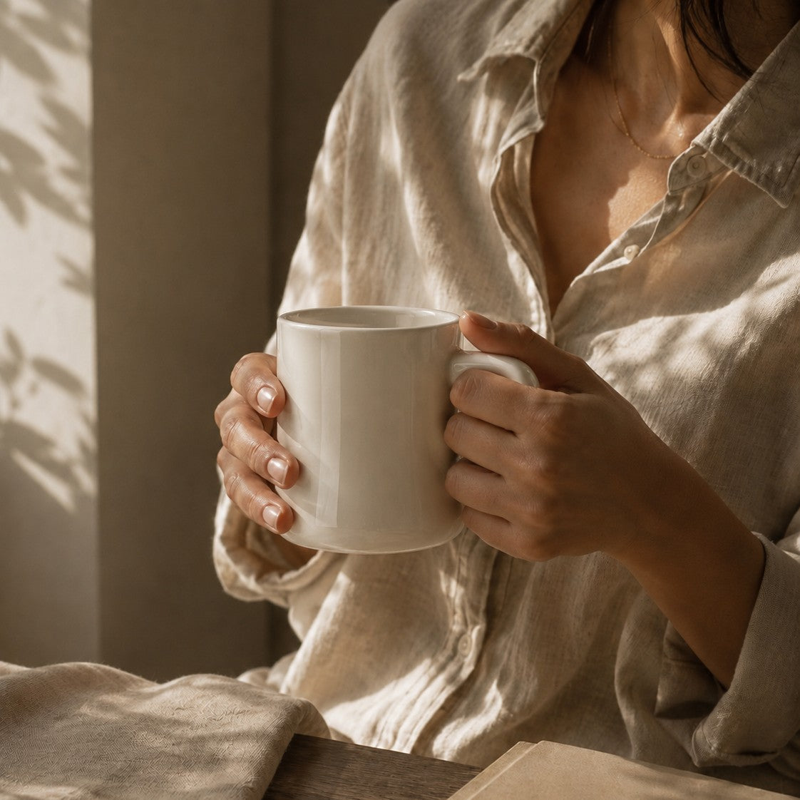 Person holding a Just Bottle Diner mug in a warm, softly lit room