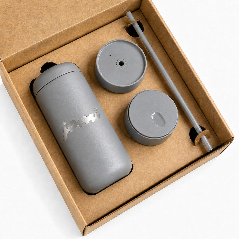 Grey Custom tumbler gift set in a brown gift box with a bold laser engraved logo, on a white background
