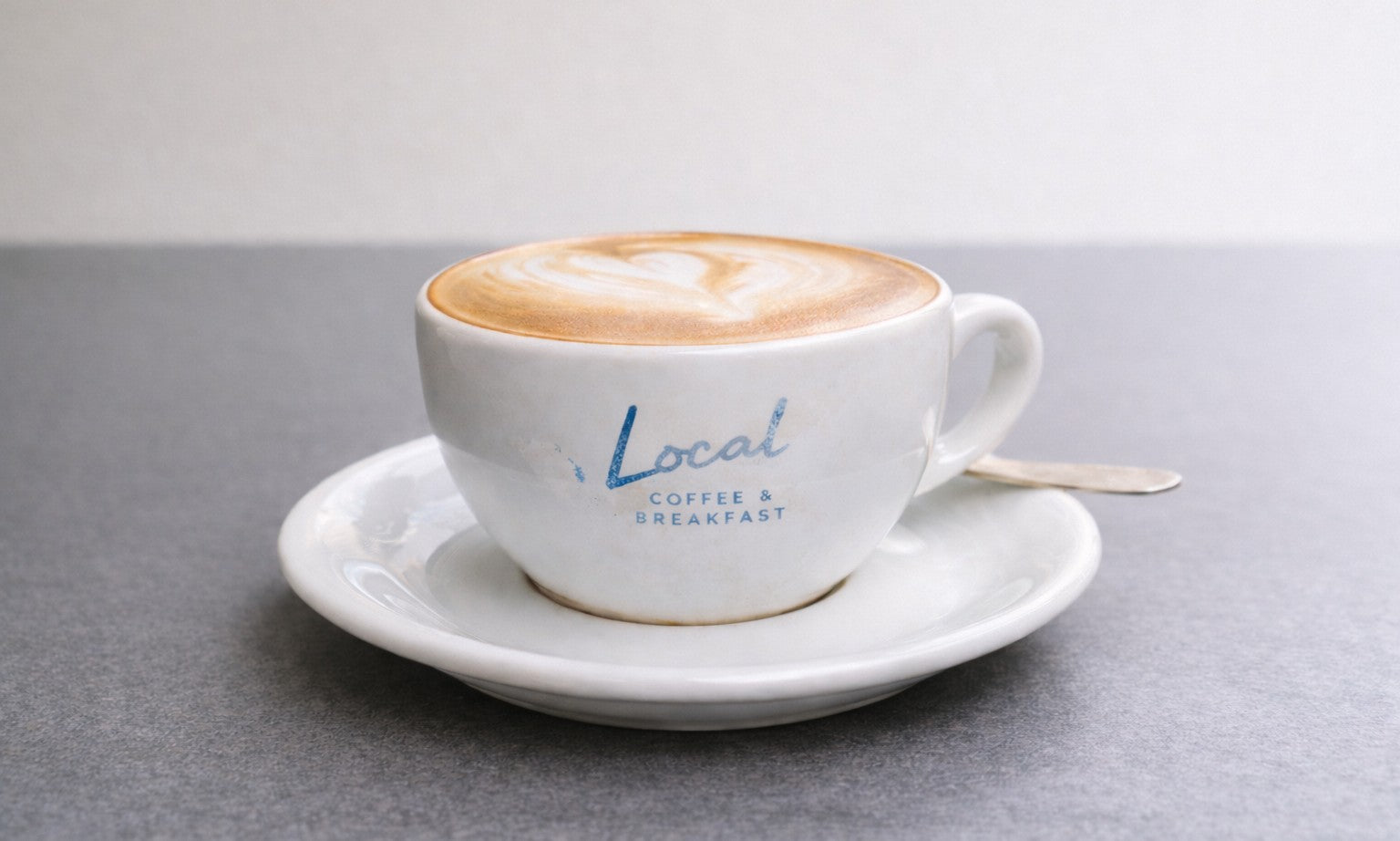 ceramic coffee cup with surface logo printing that has faded over time