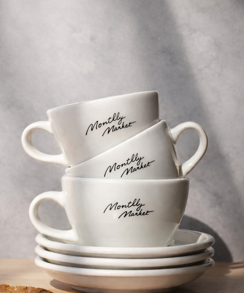 Stack of white coffee cups with custom cafe branding