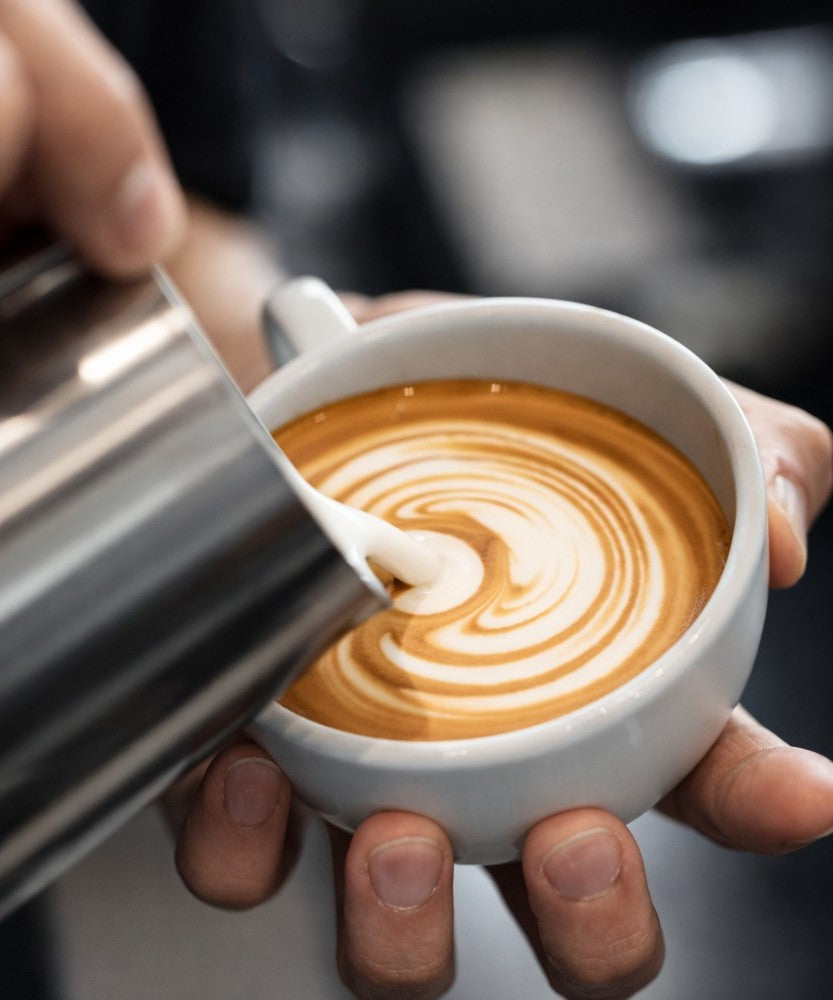 Pouring milk into an origin custom cafe cup