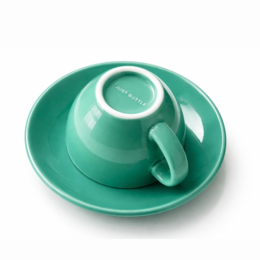 Origin ceramic coffee cup in green - underside with Just Bottle logo