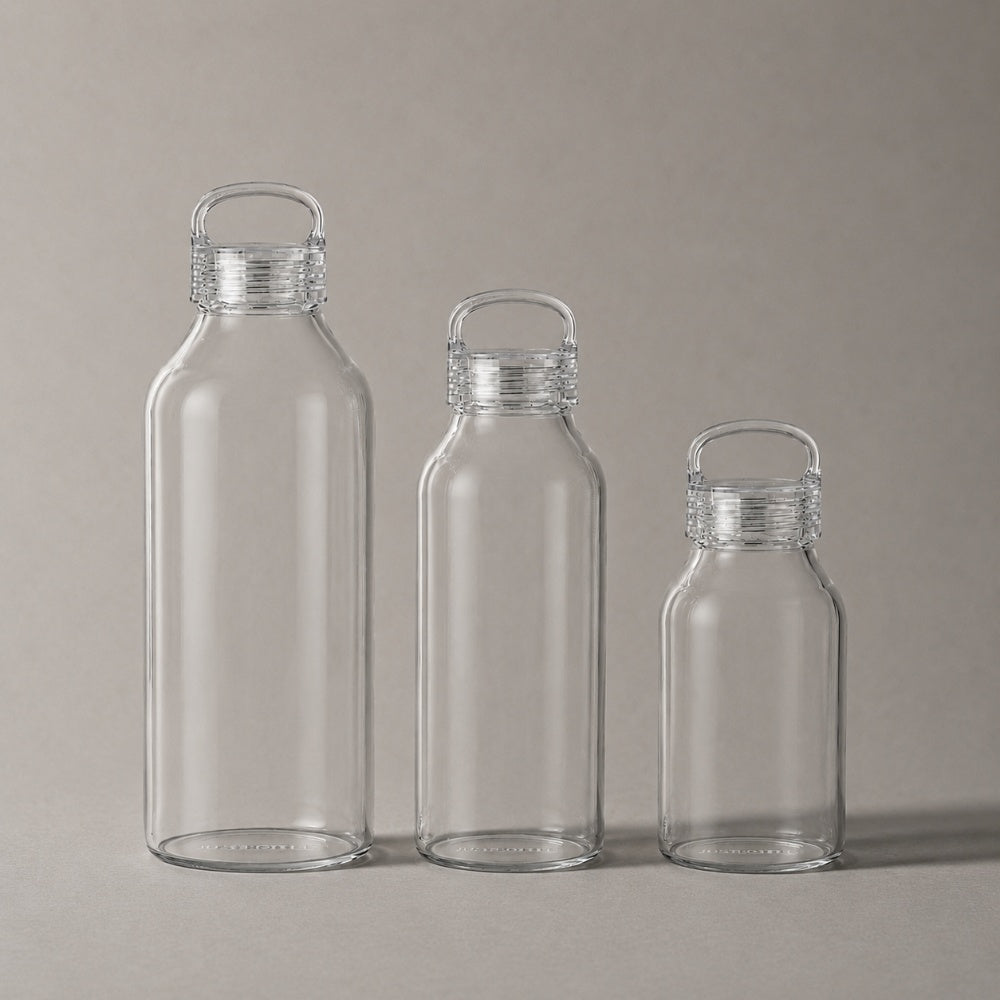 Three Just Bottle Zen glass water bottles next to each other to compare size - 300ml, 500ml and 900ml on a grey background