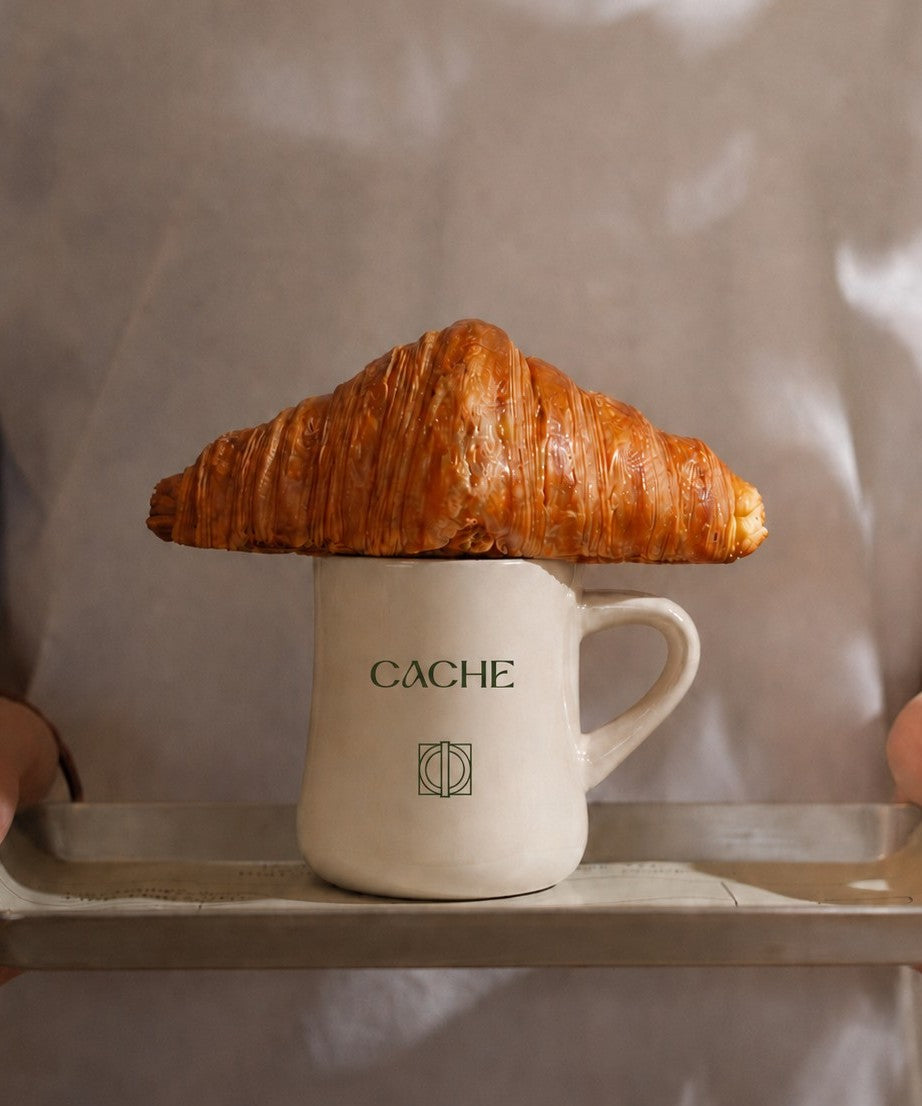 Custom diner mug with logo on a tray with pastry resting on top