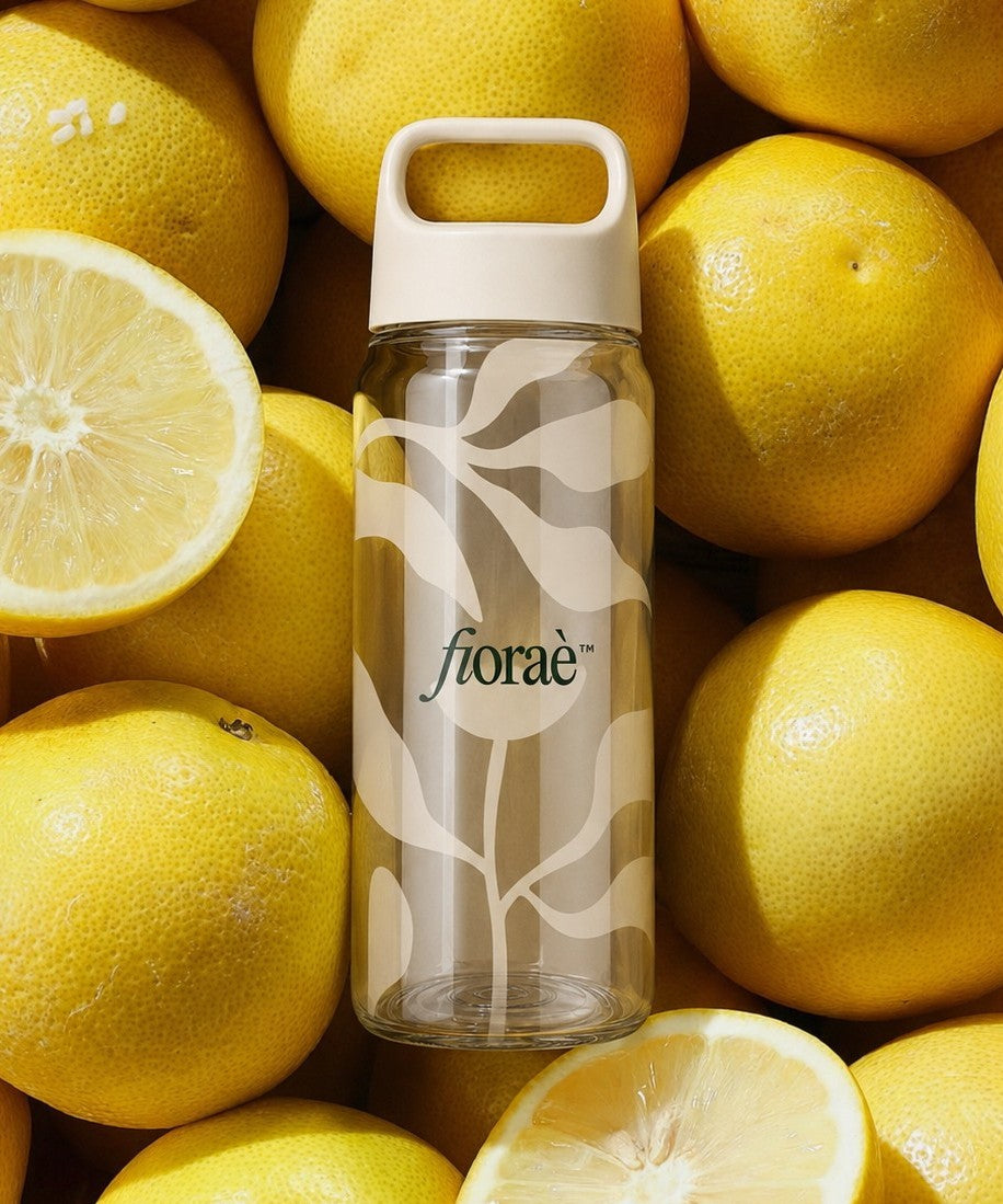 recycled rpet water bottle with custom branding resting on lemons