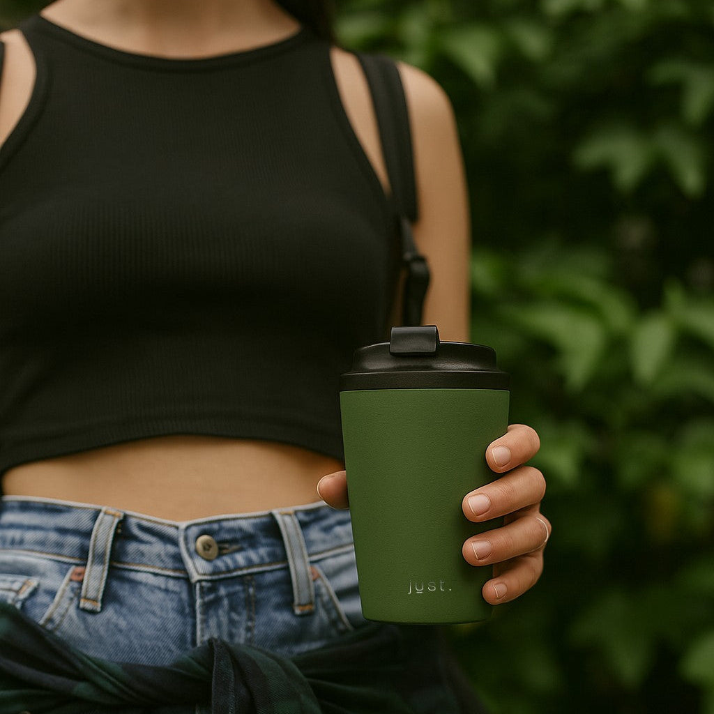 Lady holding a Brew Cup reusable coffee cup in green