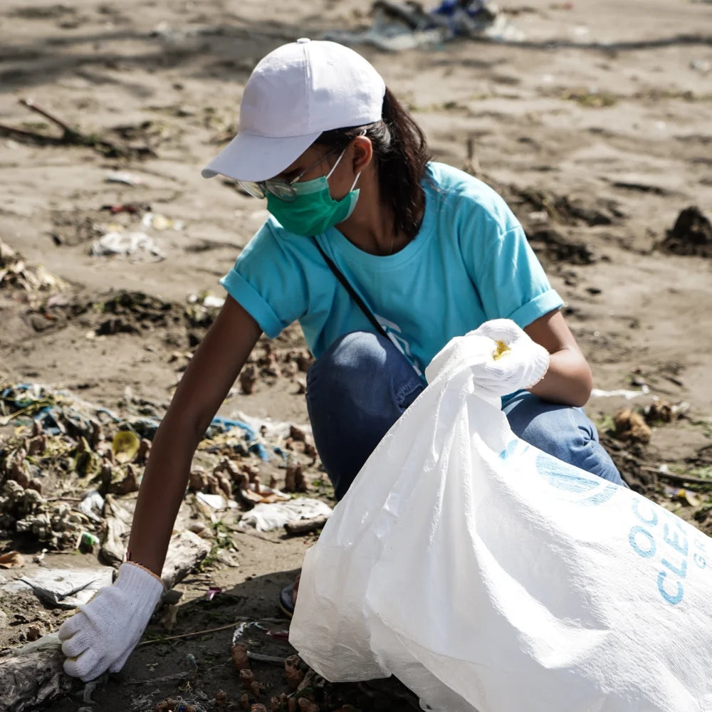 lady cleaning the beach