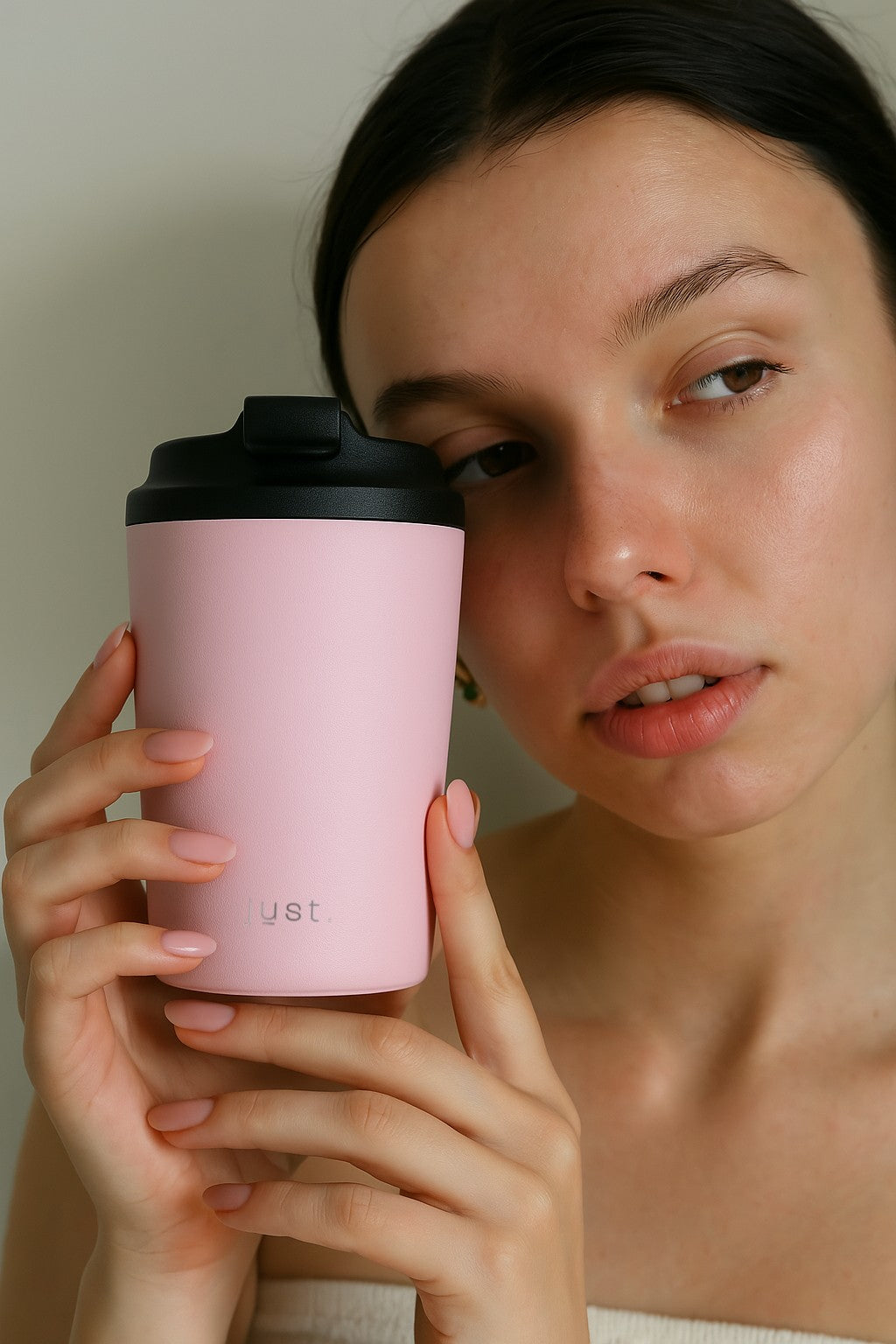 lady holding pink coffee cup
