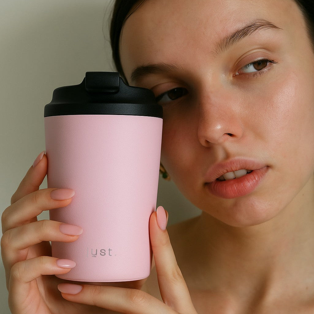 lady holding a Brew Cup reusable coffee cup in pink