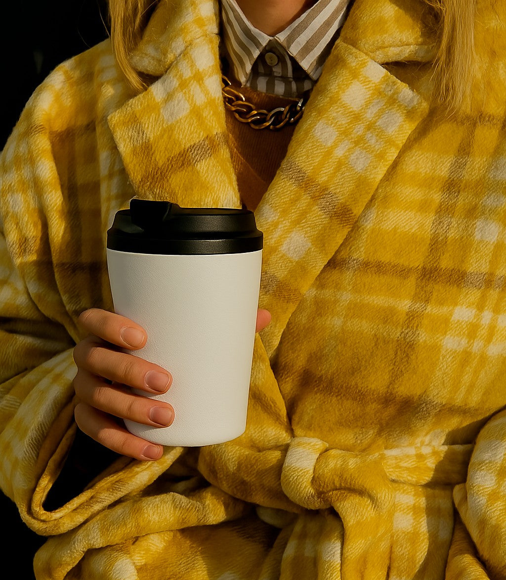 lady holding a white coffee cup