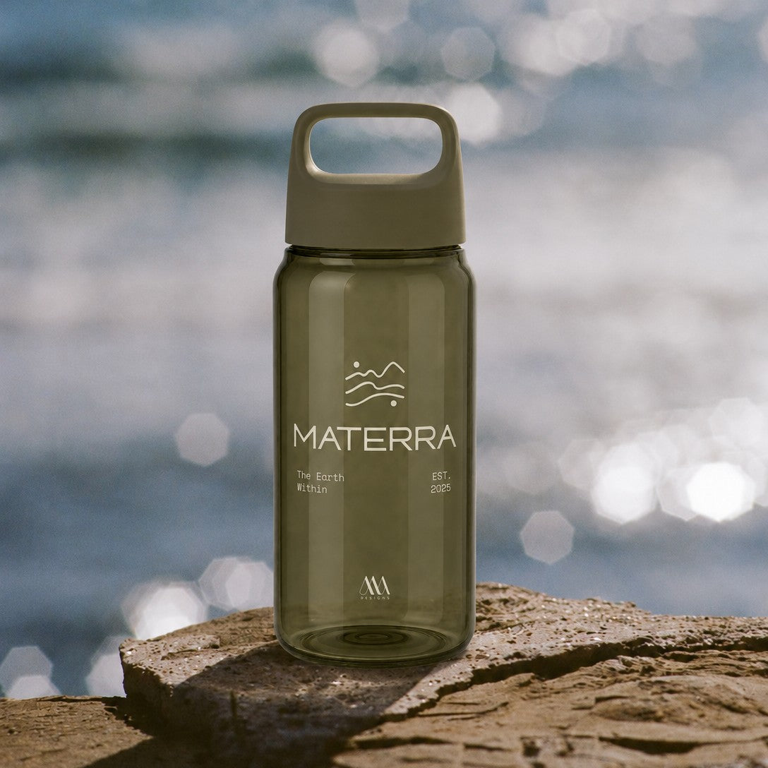 Custom branded green recycled plastic water bottle for events sitting on a rock in front of the ocean
