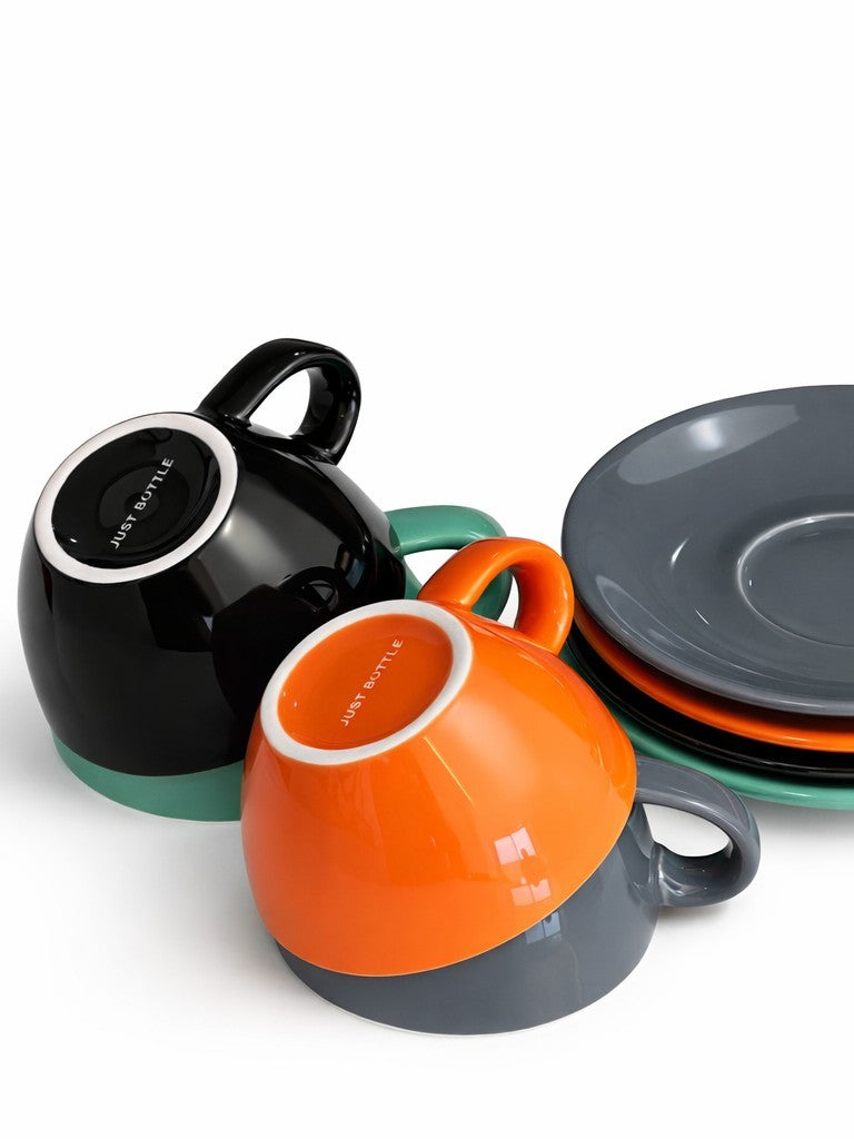 Ceramic coffee cups stacked next to saucers