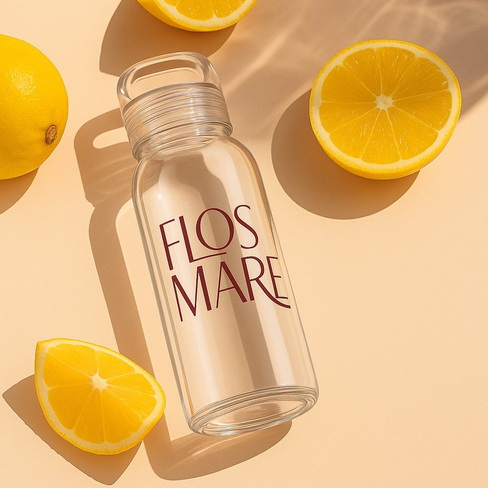 Glass water bottle with company logo next to orange slices on a beige background - 300ml / 10 oz Zen Glass Bottle by Just Bottle