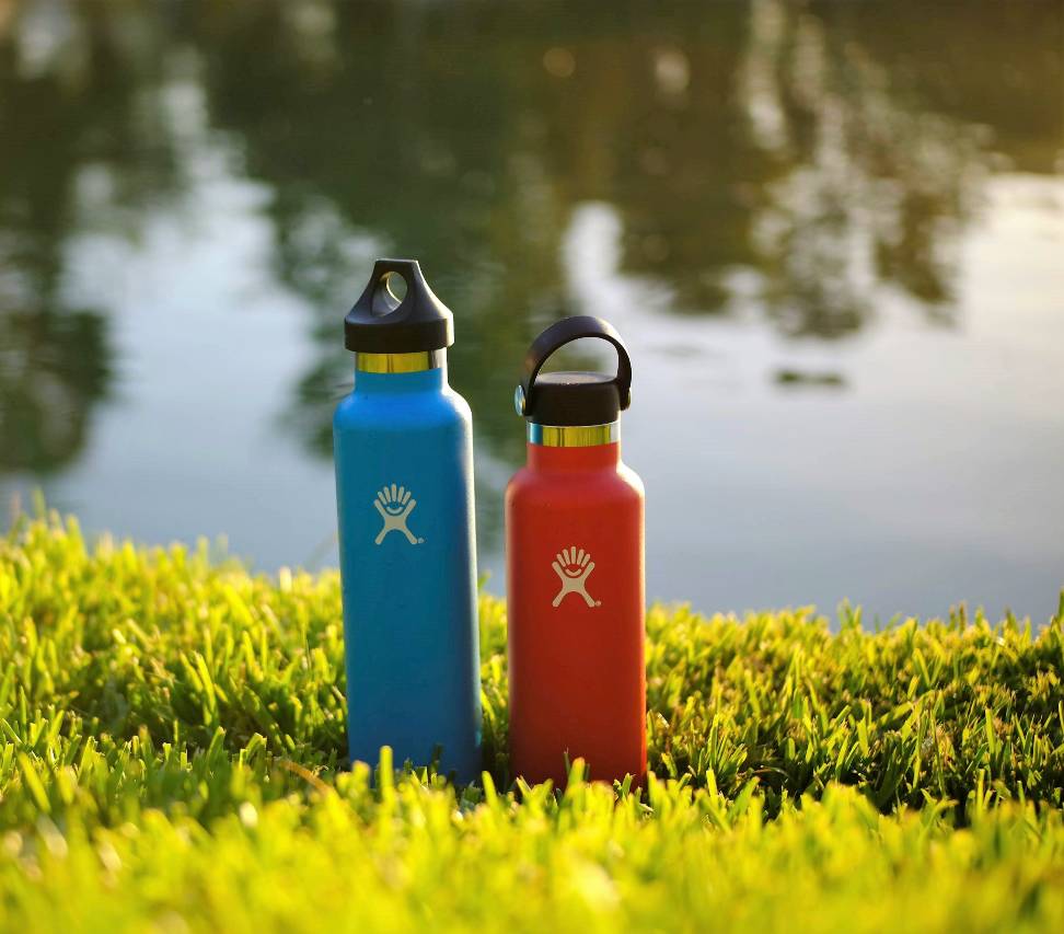 pair of hydroflask bottles on green grass
