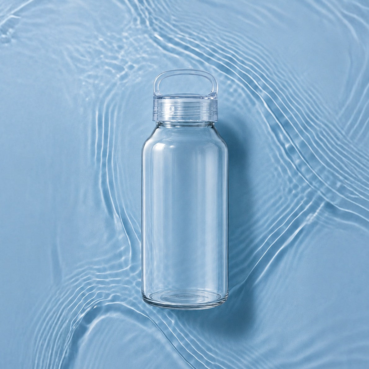 Small glass water bottle on a blue textured background - Just Bottle 300ml 10oz Zen Glass Bottle