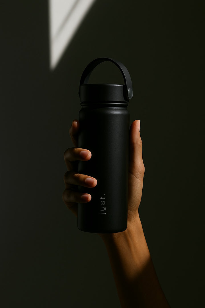 person holding black water bottle