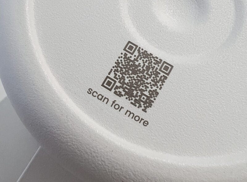 QR code engraved on bottom of white stainless steel coffee mug