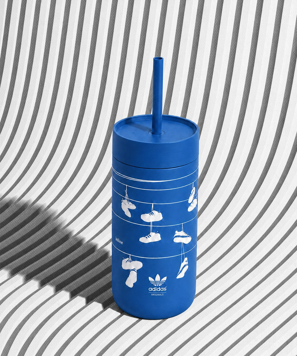 Blue custom logo stainless steel tumbler 16oz with straw lid, adidas branding on a white chair