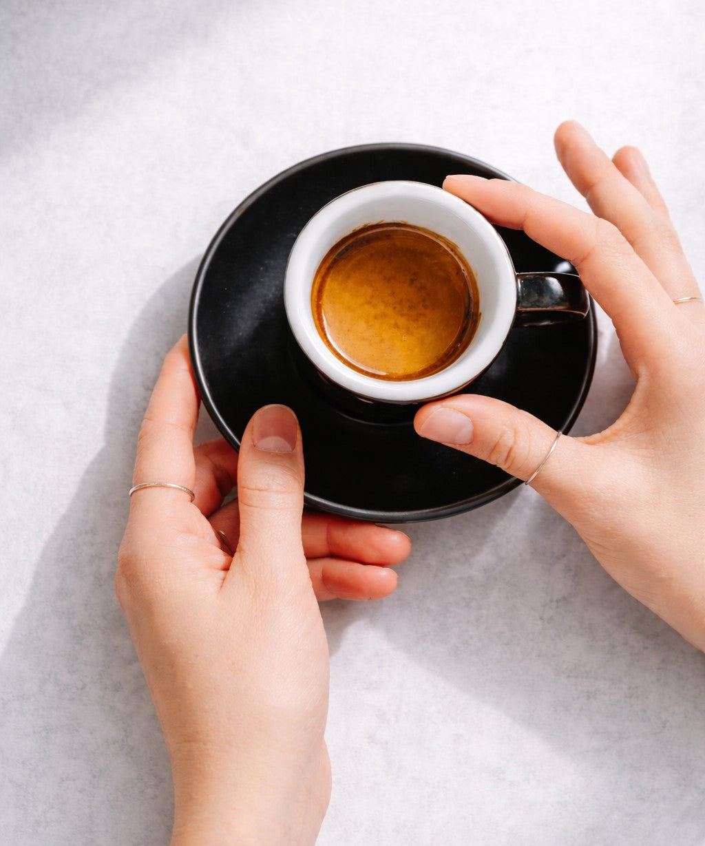 Espresso served in 75ml porcelain cup and saucer in café setting