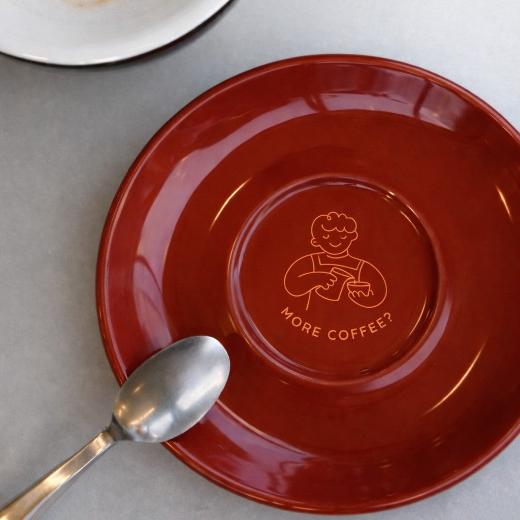 Red saucer with custom cafe logo