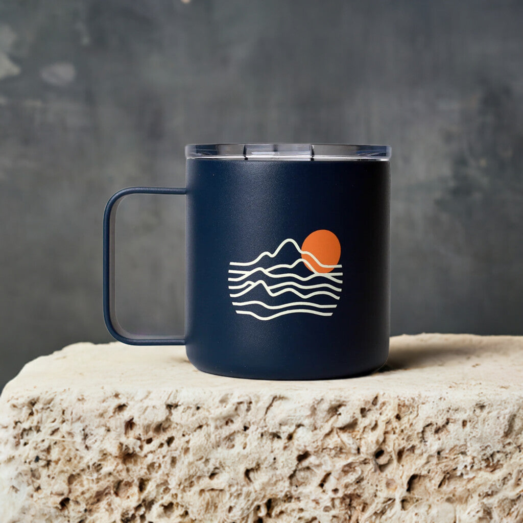 blue stainless steel camp mug with Seven Seeds Coffee colour print logo on a stone top