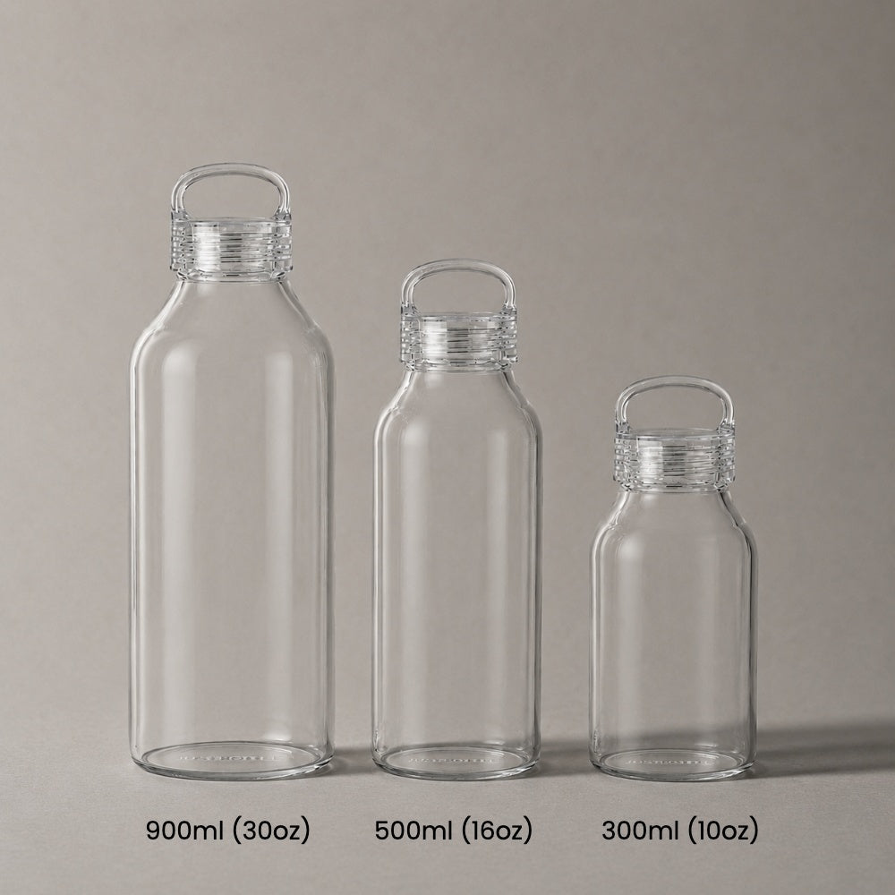 Three Just Bottle Zen glass water bottles next to each other to compare size - 300ml, 500ml and 900ml on a grey background