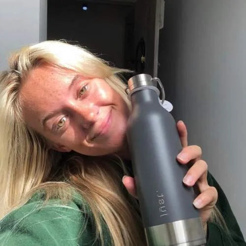 Alys Barton surfer holding a reusable bottle