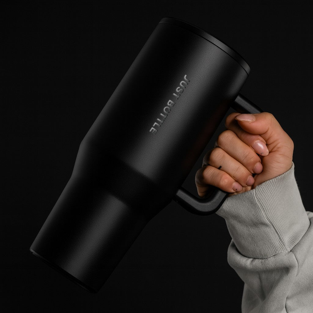 Hand holding a 40oz stainless steel tumbler with leakproof straw lid