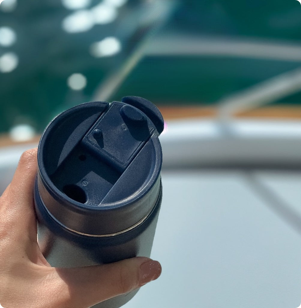 blue leakproof coffee cup on a boat