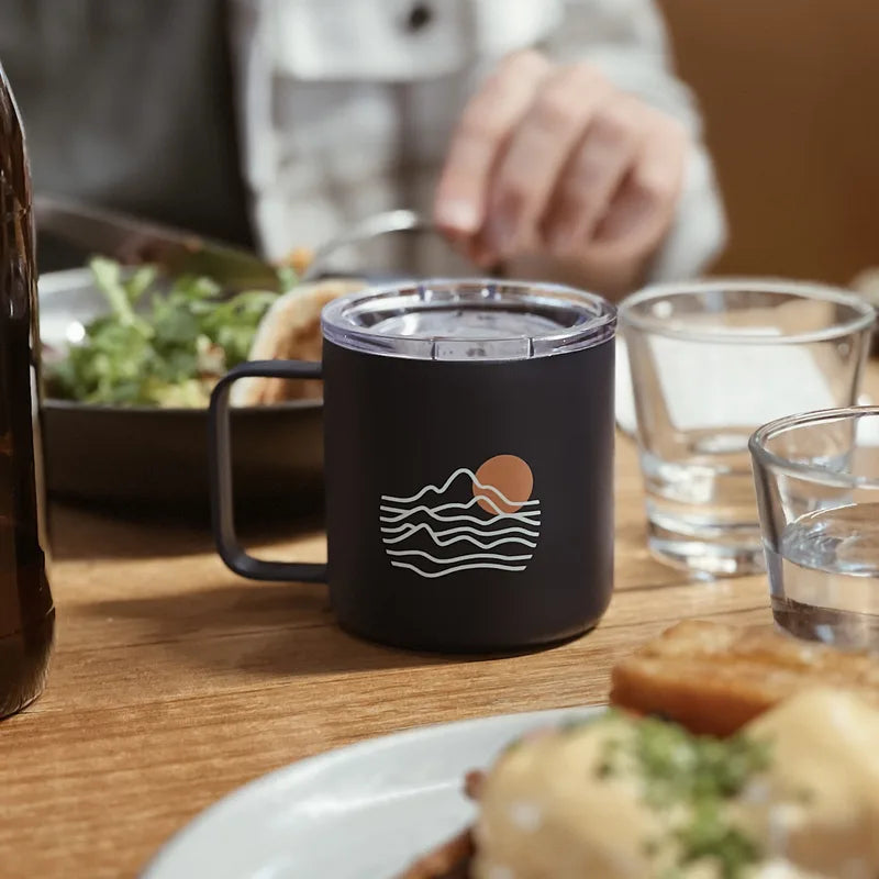 blue stainless steel mug on a table in a cafe