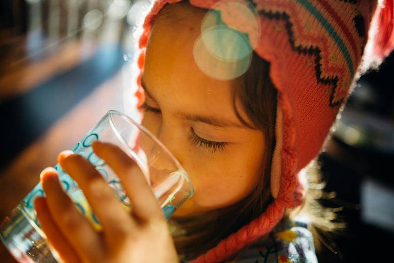 girl drinking a glass of water