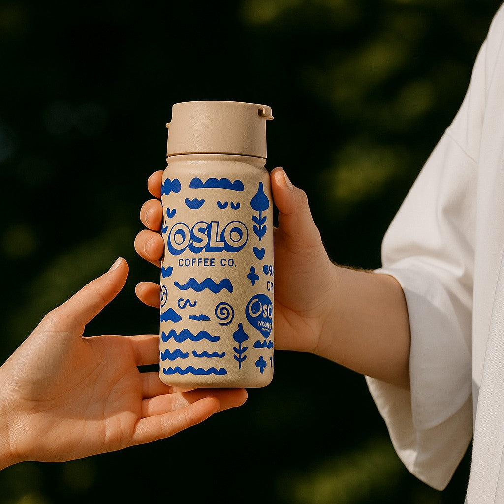 person holding a company logo coffee mug with blue olso coffee co logo