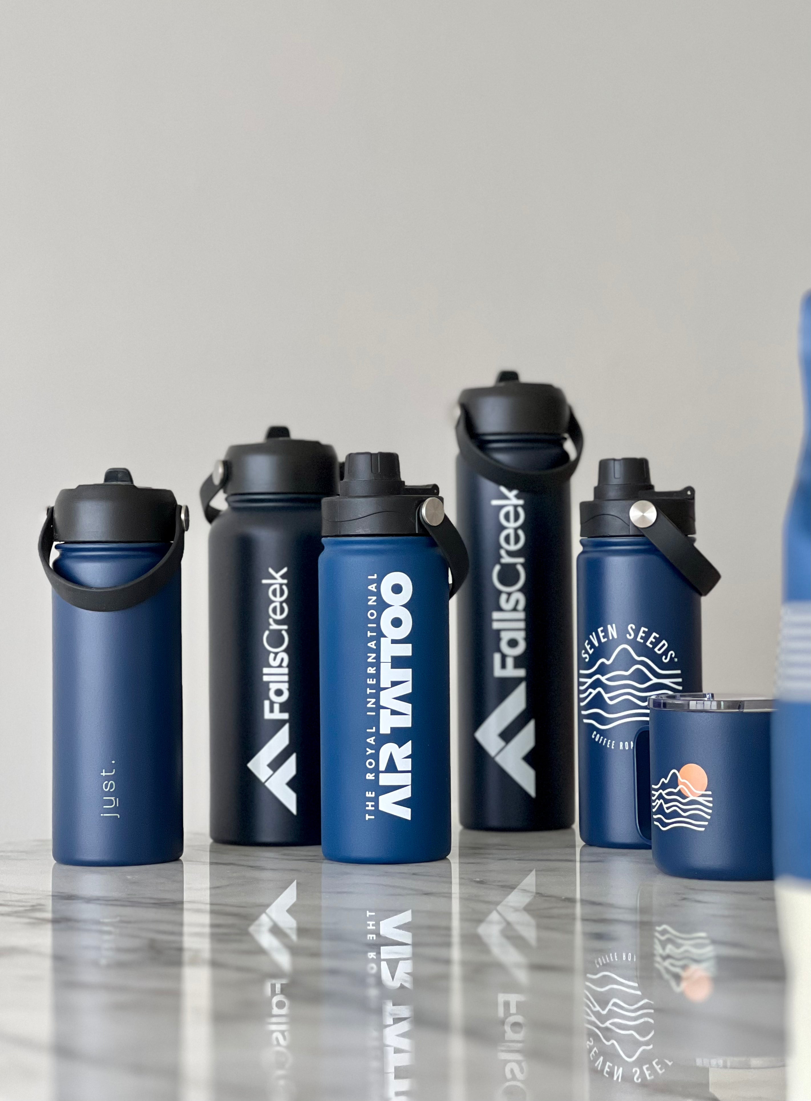 five blue custom branded stainless steel water bottles next to a custom branded mug with customised logos printed on the co brand products