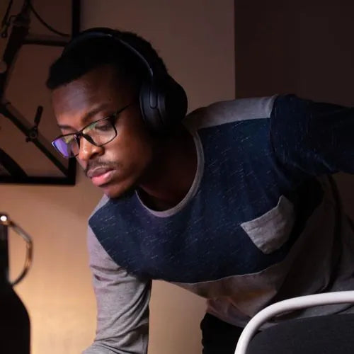 man with headphones looking at laptop