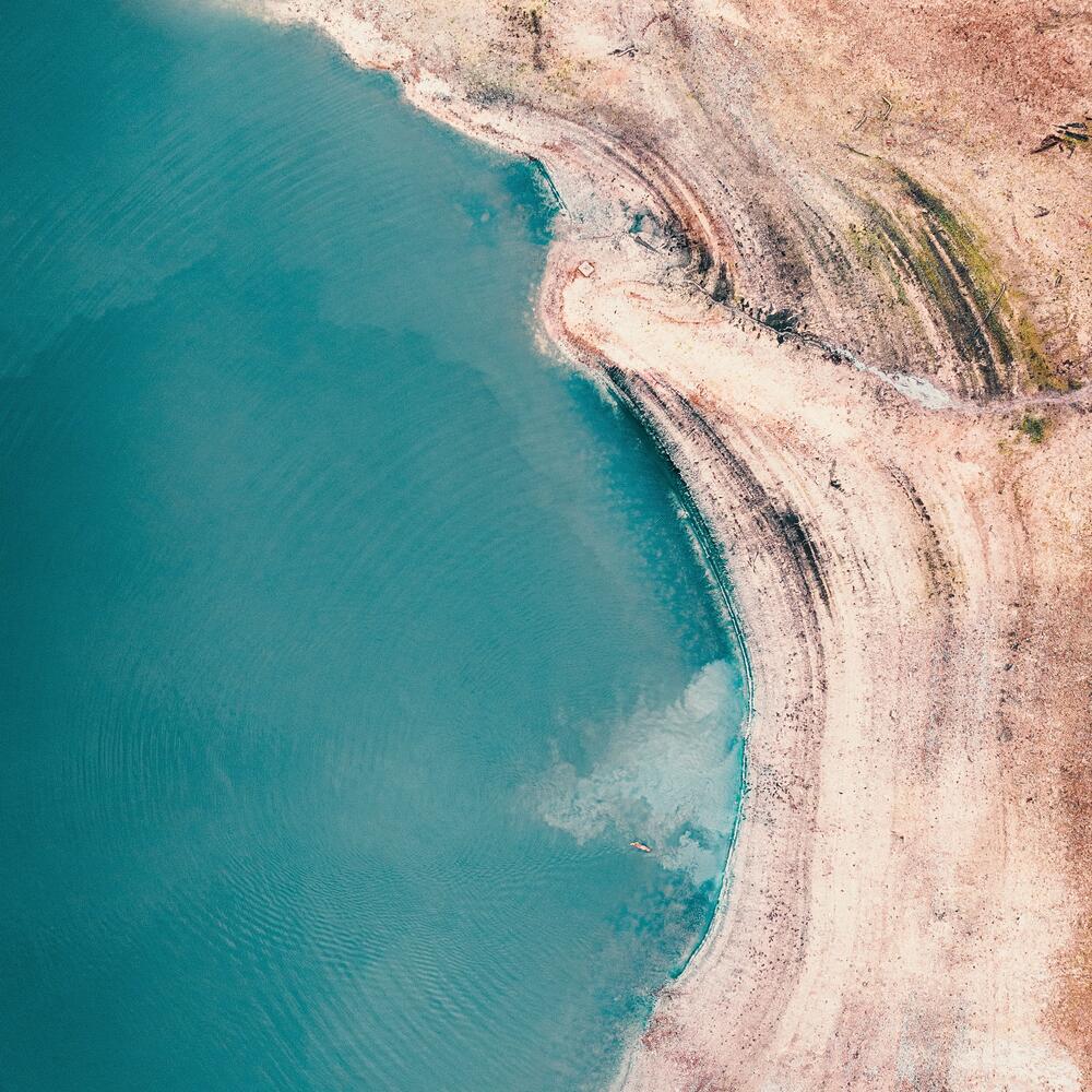 turquoise bay next to rocky beach 