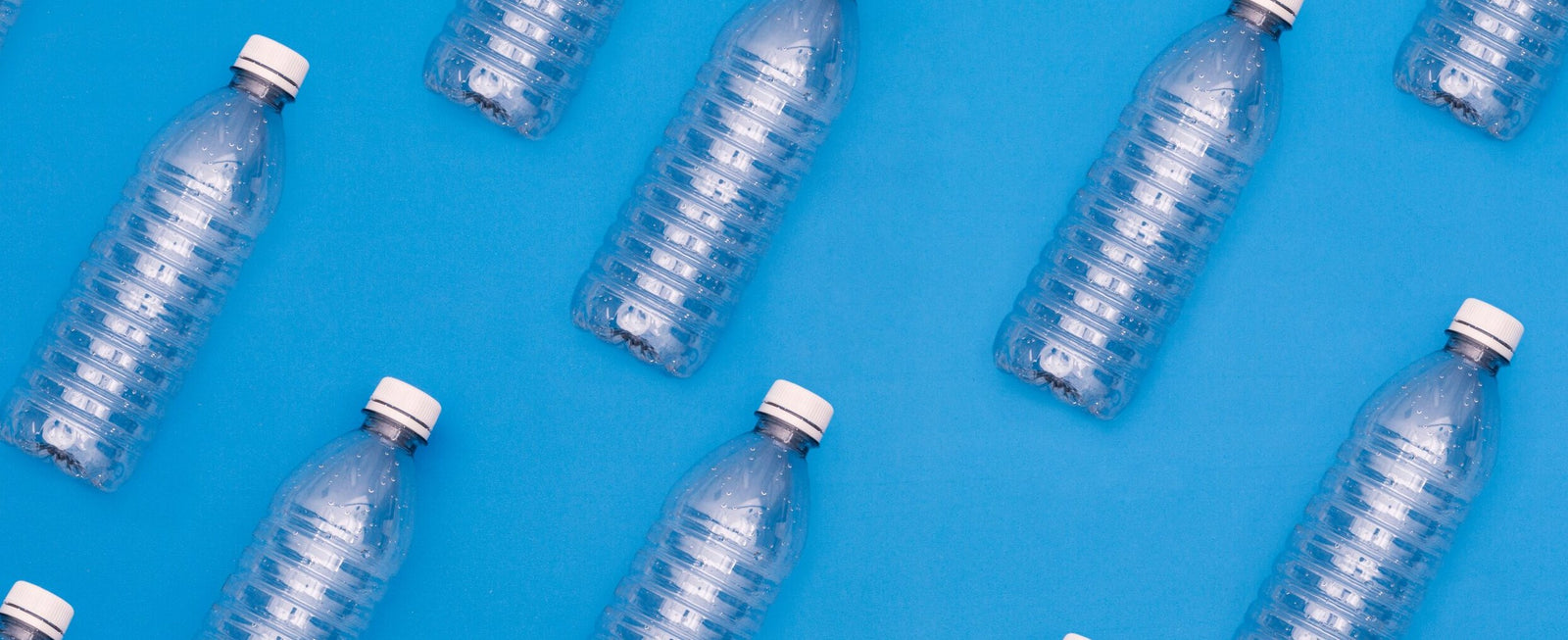 plastic water bottles with blue in the background